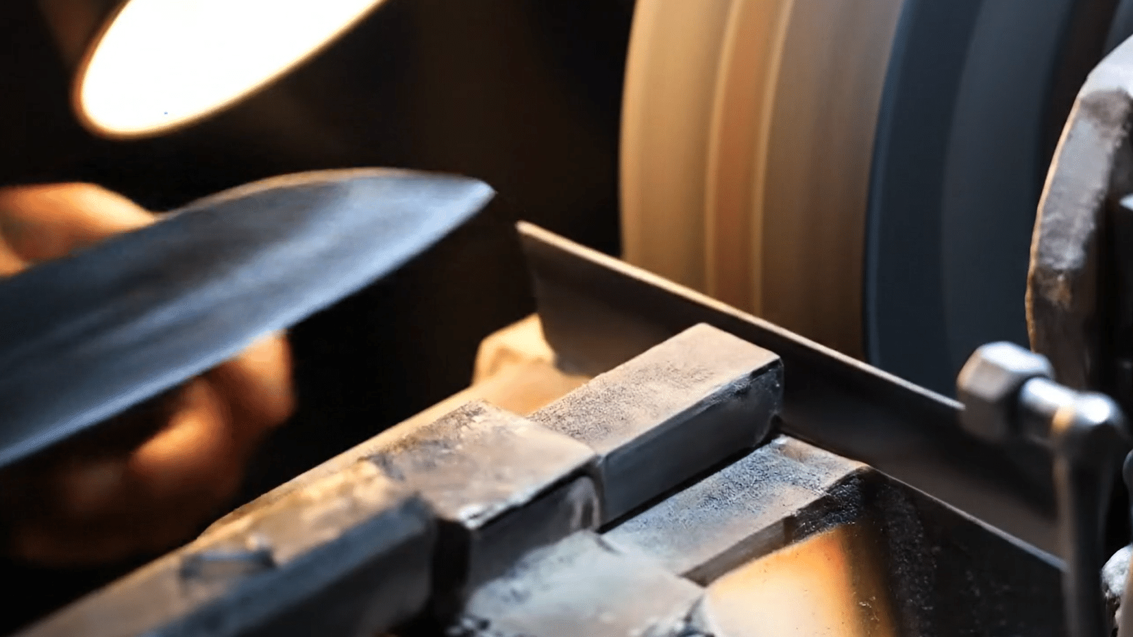 A craftsman forging steel at the anvil