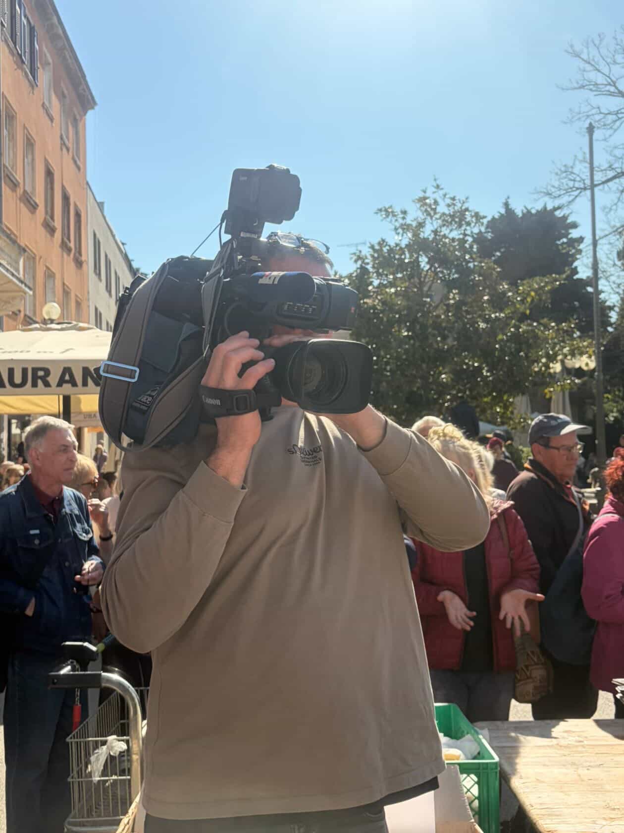 TV cameraman filming the spring food festival in Pula
