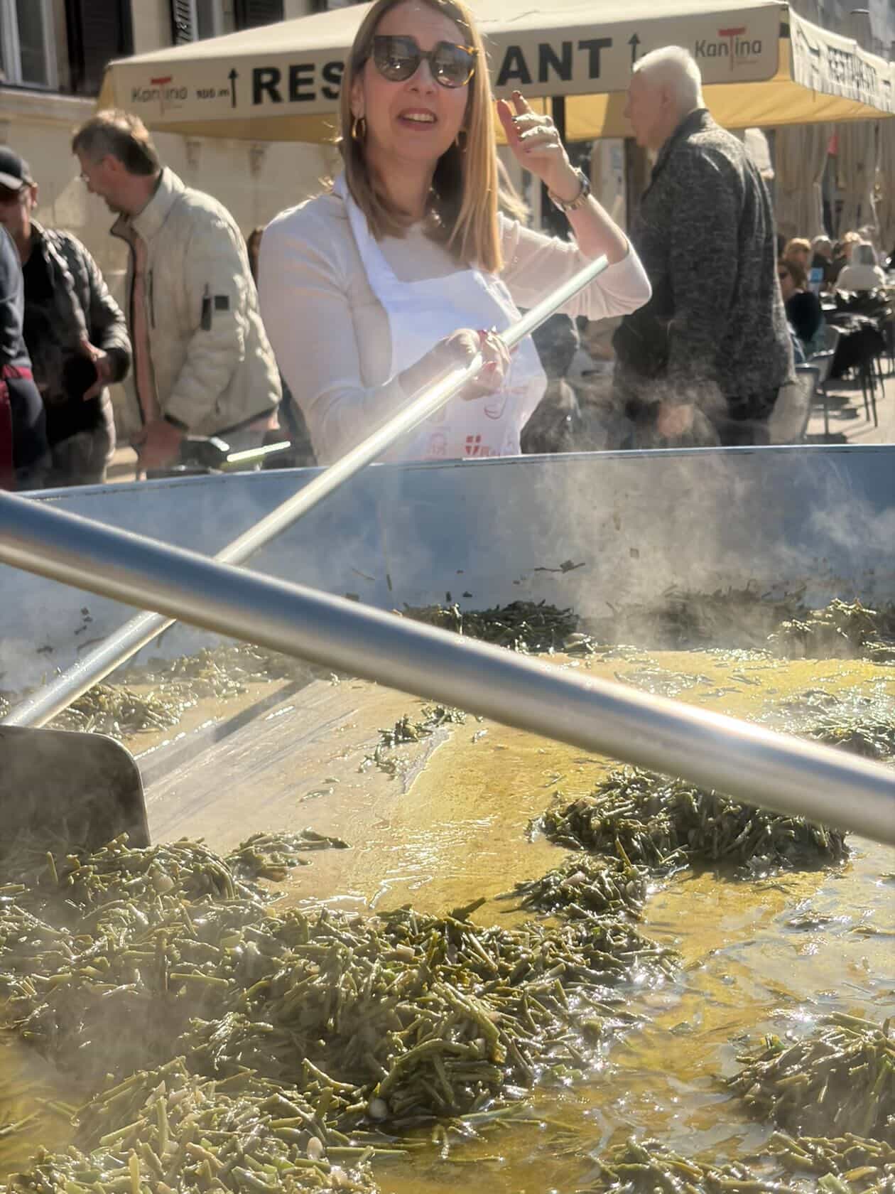 Woman stirring the giant pan at the food festival